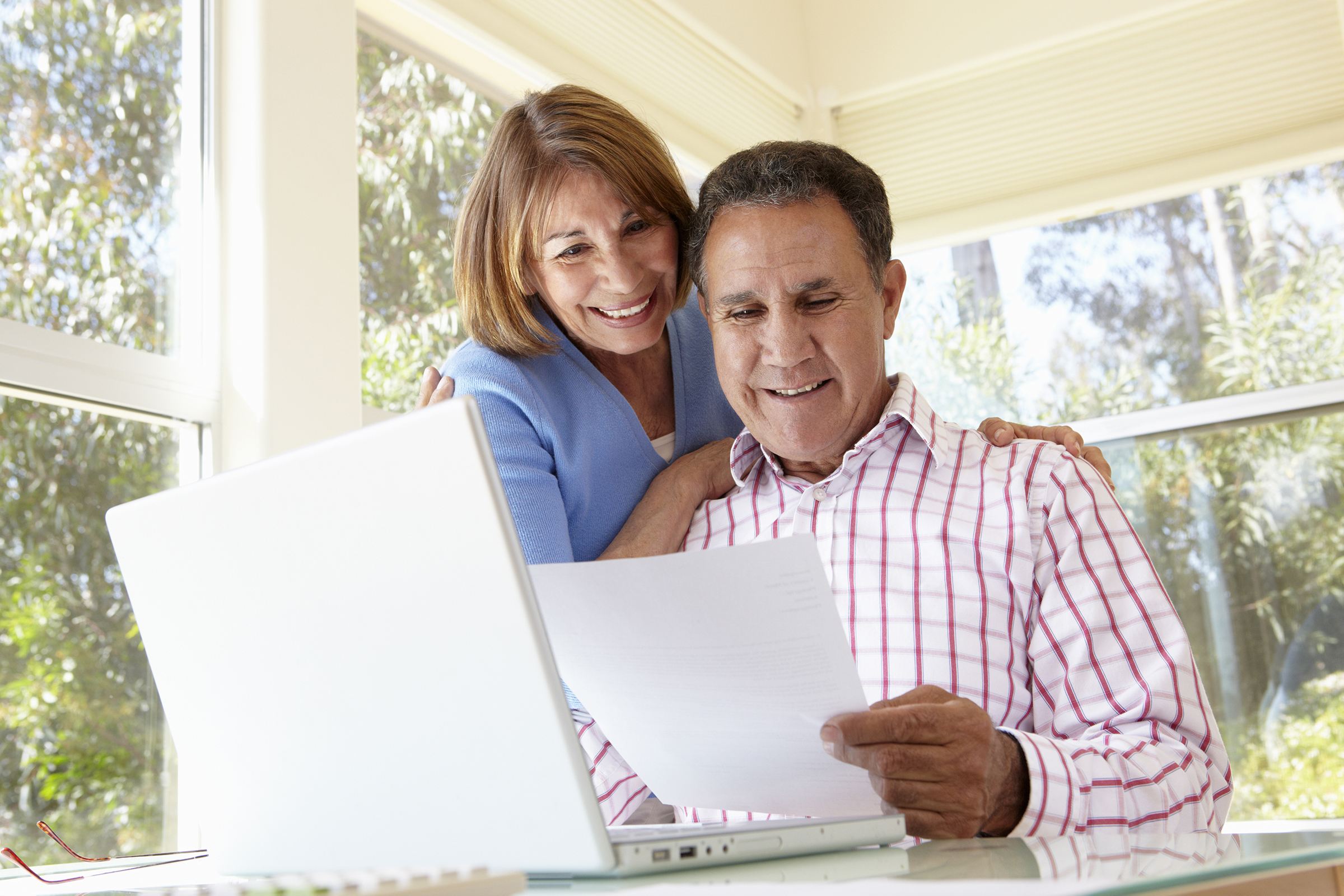 Senior Hispanic Couple Working In Home Office