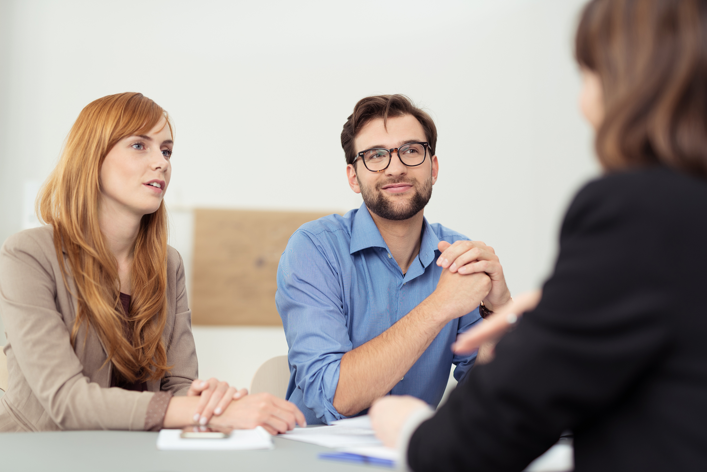 Young couple listening to their banker.