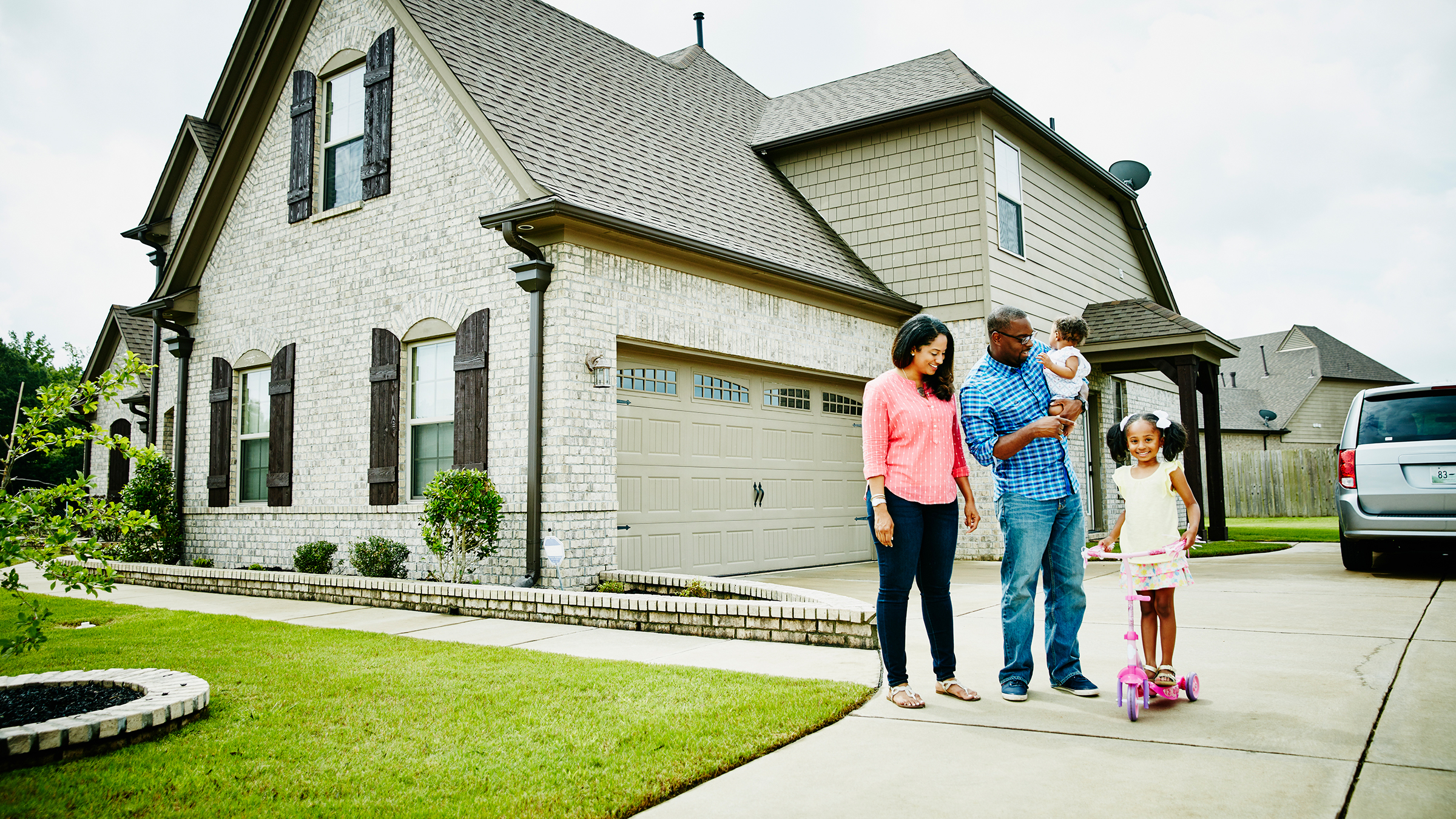 Full family in front of home
