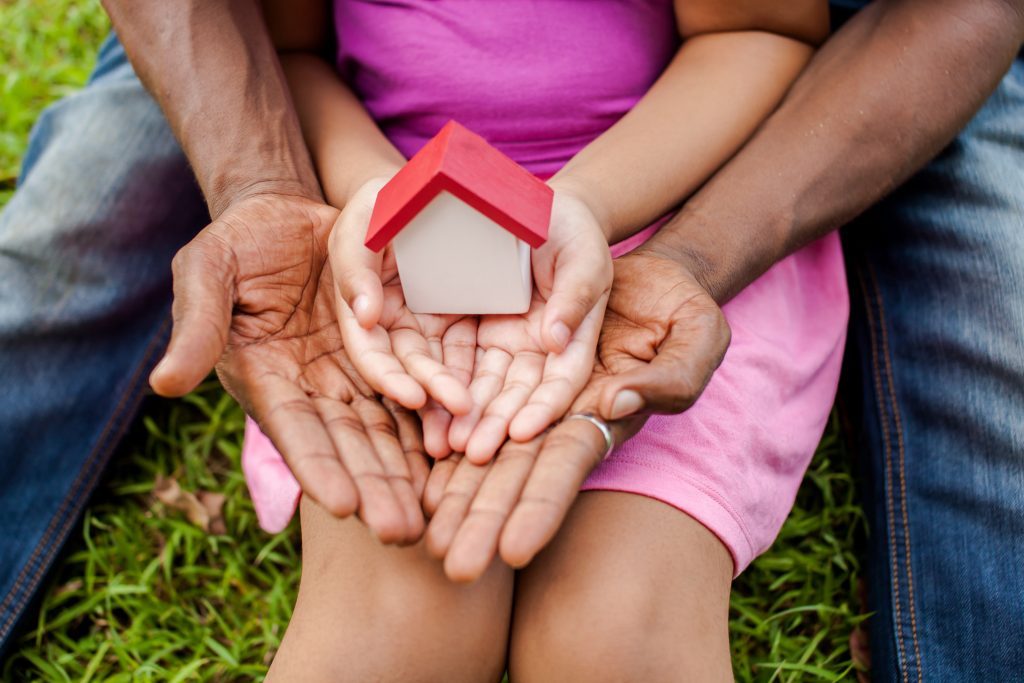 Hands of Family Holding House