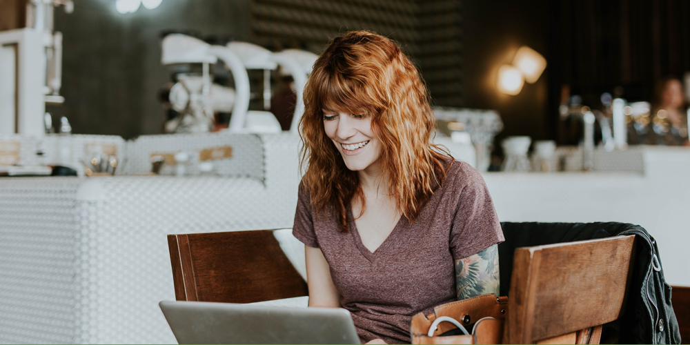 Woman on computer in coffee shop