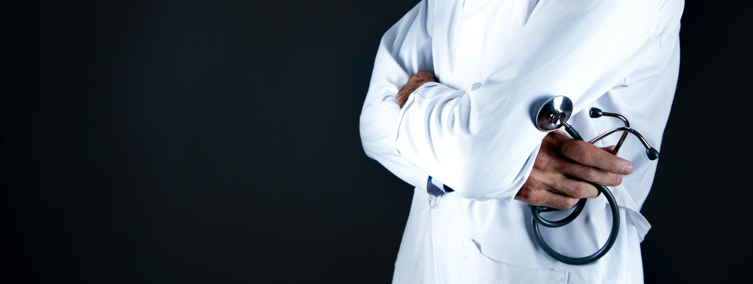 Doctor with his arms crossed holding a stethoscope
